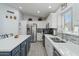 Modern kitchen with white cabinets, large island, and stainless steel appliances at 9628 E Olla Ave, Mesa, AZ 85212