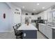 Modern kitchen with white cabinets, large island, and stainless steel appliances at 9628 E Olla Ave, Mesa, AZ 85212