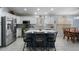 Modern kitchen with white cabinets, large island, and stainless steel appliances at 9628 E Olla Ave, Mesa, AZ 85212
