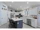 Modern kitchen with white cabinets, large island, and stainless steel appliances at 9628 E Olla Ave, Mesa, AZ 85212