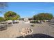 Spacious backyard with mature trees and a gravel area at 9821 W Cedar Dr, Sun City, AZ 85351
