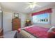 Bedroom with comfortable bed, dresser, TV, and built-in shelving at 9821 W Cedar Dr, Sun City, AZ 85351