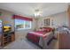 Cozy bedroom with a comfortable bed, TV, and ample closet space at 9821 W Cedar Dr, Sun City, AZ 85351
