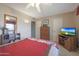 Bedroom with comfortable bed, dresser, TV, and built-in shelving at 9821 W Cedar Dr, Sun City, AZ 85351