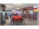 Bright dining area with a red table and four chairs, adjacent to the living room and kitchen at 9821 W Cedar Dr, Sun City, AZ 85351