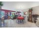 Dining area with red tablecloth and view into living room at 9821 W Cedar Dr, Sun City, AZ 85351