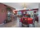 Dining room with red table setting and kitchen access at 9821 W Cedar Dr, Sun City, AZ 85351