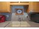 Clean kitchen sink with double basin and a modern faucet, featuring granite countertops at 9821 W Cedar Dr, Sun City, AZ 85351