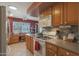 Modern kitchen boasting ample counter space, wood cabinets, and a full suite of appliances at 9821 W Cedar Dr, Sun City, AZ 85351