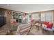 Spacious sunroom with multiple seating areas, large windows, and access to the outdoors at 9821 W Cedar Dr, Sun City, AZ 85351