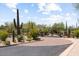 Gated entrance to a luxury community with desert landscaping at 10260 E White Feather Ln # 2003, Scottsdale, AZ 85262