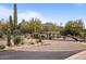 Desert landscape entry to guard gated community with large cacti and mountains in background at 10260 E White Feather Ln # 2003, Scottsdale, AZ 85262