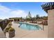 Community pool with lounge chairs and a fireplace at 10260 E White Feather Ln # 2003, Scottsdale, AZ 85262