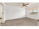 Spacious bedroom with ceiling fan and carpet at 10330 W Thunderbird Blvd # C119, Sun City, AZ 85351