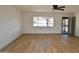 Living room with hardwood floors and brick accent wall at 10331 W Willie Low Cir, Sun City, AZ 85351