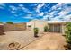 Large backyard with gravel and access to back of house at 10461 W Devonshire Ave, Phoenix, AZ 85037