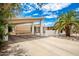 Mid-century home with carport, palm trees, and rock landscaping at 10461 W Devonshire Ave, Phoenix, AZ 85037