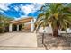 Mid-century home with carport, palm trees, and rock landscaping at 10461 W Devonshire Ave, Phoenix, AZ 85037