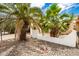 Landscaped front yard with palm trees and rock gardens at 10461 W Devonshire Ave, Phoenix, AZ 85037