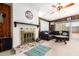 Living room with fireplace, wood paneling and large windows at 10461 W Devonshire Ave, Phoenix, AZ 85037