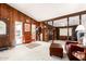 Bright living room with wood paneling, comfy seating, and an inviting atmosphere at 10461 W Devonshire Ave, Phoenix, AZ 85037