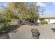 Large backyard with gravel and mature trees, offering privacy at 10631 W Brookside Dr, Sun City, AZ 85351