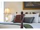 Close-up of a bed with a wooden headboard and pillows, showcasing a calm and inviting ambiance at 10631 W Brookside Dr, Sun City, AZ 85351