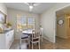 Bright dining area with a round table and four chairs, adjacent to kitchen at 10631 W Brookside Dr, Sun City, AZ 85351