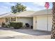 Ranch-style home with attached garage and manicured landscaping at 10631 W Brookside Dr, Sun City, AZ 85351