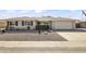 Landscaped front yard with a two-car garage at 10631 W Brookside Dr, Sun City, AZ 85351