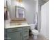 Stylish bathroom with light green vanity and gold fixtures at 10713 E Hawk Ave, Mesa, AZ 85212