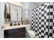 Modern bathroom with dark vanity and checkered shower curtain at 10713 E Hawk Ave, Mesa, AZ 85212