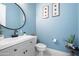 Clean powder room with white vanity and light blue walls at 10713 E Hawk Ave, Mesa, AZ 85212