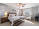 Main bedroom with wooden bed frame and sitting area at 10713 E Hawk Ave, Mesa, AZ 85212