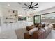 Living room boasts a brown sectional sofa and built-in shelving at 10713 E Hawk Ave, Mesa, AZ 85212