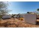 Backyard view showcasing storage sheds and a partially fenced area at 1121 S Lawther Dr, Apache Junction, AZ 85120