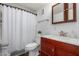 Clean bathroom with wood vanity and shower/tub combo at 1121 S Lawther Dr, Apache Junction, AZ 85120