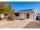 Single story home with an orange door and a gravel driveway at 1121 S Lawther Dr, Apache Junction, AZ 85120