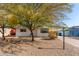 White single story home with a landscaped front yard and a covered entryway at 1121 S Lawther Dr, Apache Junction, AZ 85120