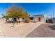 Single story home with an orange door, and a landscaped front yard at 1121 S Lawther Dr, Apache Junction, AZ 85120