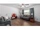 Living room with gray sofa, wood floors, and ceiling fan at 1121 S Lawther Dr, Apache Junction, AZ 85120