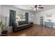 Living room with gray sofa, wood floors, and ceiling fan at 1121 S Lawther Dr, Apache Junction, AZ 85120