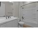 Clean bathroom with a single sink vanity, white tiling, and a shower-tub combination at 12316 W Parkway Ln, Avondale, AZ 85323
