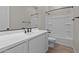 Well-lit bathroom boasts a sleek vanity with black fixtures and a shower-tub combo at 12316 W Parkway Ln, Avondale, AZ 85323