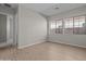 Bright bedroom with wood-look floors and large windows at 12316 W Parkway Ln, Avondale, AZ 85323
