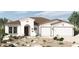 New home exterior with Spanish tile roof and two-car garage at 12316 W Parkway Ln, Avondale, AZ 85323