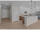 Modern kitchen with white cabinets, an island with pendant lights, and stainless steel appliances at 12316 W Parkway Ln, Avondale, AZ 85323
