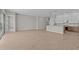 Spacious living room flows to a kitchen area with wood-look tile floors and natural light at 12316 W Parkway Ln, Avondale, AZ 85323