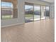Bright living room featuring wood-look tile floors and large sliding glass doors to backyard at 12316 W Parkway Ln, Avondale, AZ 85323