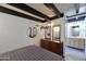 Bedroom with wood dresser, round mirror and en-suite bathroom at 1308 E Gardenia Dr, Phoenix, AZ 85020